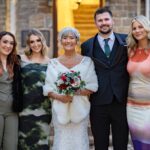 Bride with friends outside venue entrance