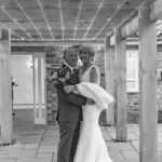 Bride and groom under fairy light walkway